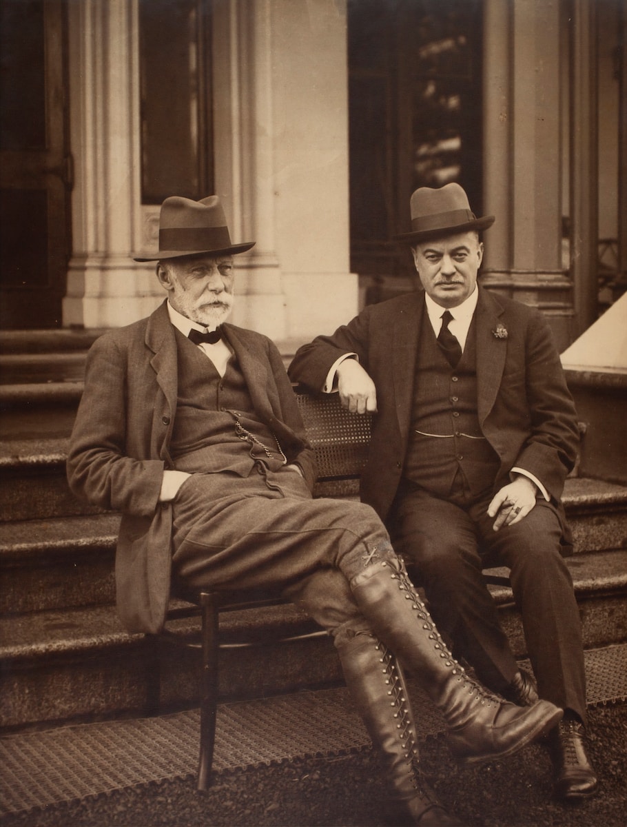 Photo by Museums Victoria man in black suit sitting on stairs